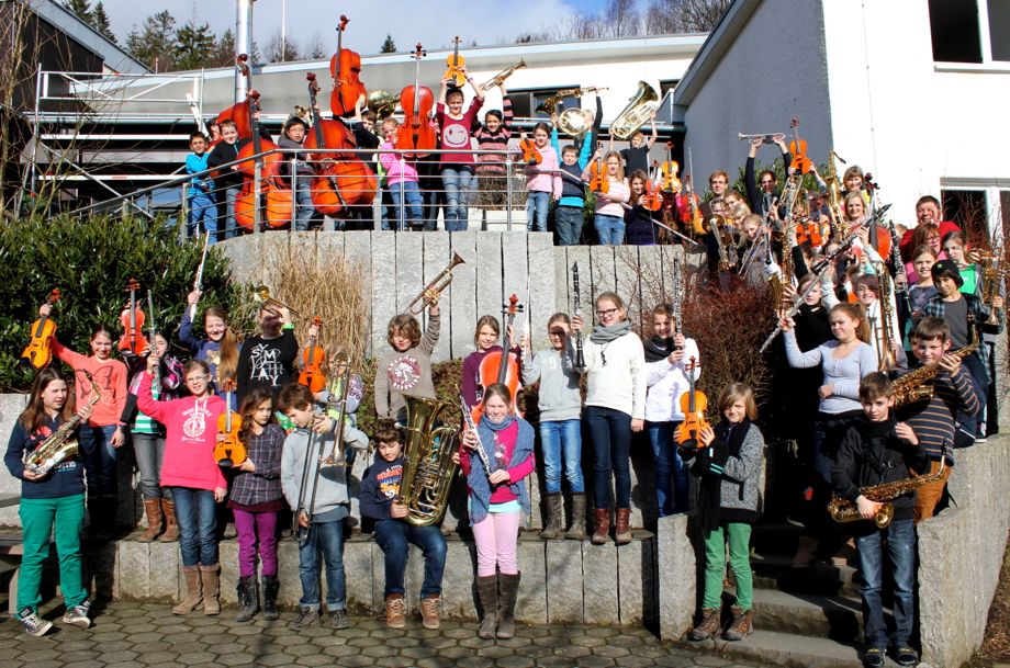 Kinder einer Musikklasse musizieren gemeinsam mit ihren Instrumenten